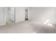 Bedroom featuring plush carpeting and easy access to an ensuite bathroom and walk-in closet for comfortable living at 164 Clove Hitch Ln, Fuquay Varina, NC 27526