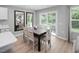 Dining area with light-colored wood floors and a sliding door to the backyard at 164 Clove Hitch Ln, Fuquay Varina, NC 27526