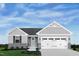 Charming single-story home with stone accents, light gray siding, and a two-car garage at 164 Clove Hitch Ln, Fuquay Varina, NC 27526