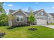 Beautiful home with stone accents, lush green lawn, and professional landscaping at 164 Clove Hitch Ln, Fuquay Varina, NC 27526