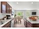 Modern kitchen with granite countertops, wood cabinets, stainless steel appliances and eat in dining area at 164 Clove Hitch Ln, Fuquay Varina, NC 27526