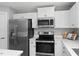Bright kitchen featuring white cabinets, stainless steel appliances, and light countertops at 164 Clove Hitch Ln, Fuquay Varina, NC 27526