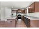 Modern kitchen with stainless steel appliances, granite counters, and wood cabinets at 164 Clove Hitch Ln, Fuquay Varina, NC 27526