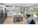 Open concept kitchen and dining area with center island with barstool seating and stainless appliances at 164 Clove Hitch Ln, Fuquay Varina, NC 27526