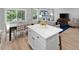 Open-concept kitchen and dining area with light wood floors and an island at 164 Clove Hitch Ln, Fuquay Varina, NC 27526