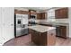 Modern kitchen with stainless steel appliances, granite counters, and wood cabinets at 164 Clove Hitch Ln, Fuquay Varina, NC 27526