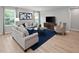 Cozy living room with modern furnishings, including sofas, an accent chair, and stylish decor at 164 Clove Hitch Ln, Fuquay Varina, NC 27526