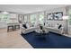 Bright living room with two sofas, a stylish round coffee table and an open floorplan to the dining area at 164 Clove Hitch Ln, Fuquay Varina, NC 27526