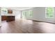 Open-concept living room with hardwood floors, natural light, and access to a sliding glass door for seamless indoor-outdoor living at 164 Clove Hitch Ln, Fuquay Varina, NC 27526