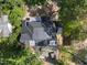 Aerial view of a home with a newly installed dark roof amidst mature trees at 508 Northwood Dr, Raleigh, NC 27609