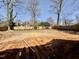 Muddy backyard surrounded by a new wooden fence, offering privacy and potential for landscaping and outdoor activities at 508 Northwood Dr, Raleigh, NC 27609