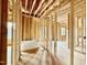 A bathroom under construction featuring the stud framing, plumbing, and a freestanding white soaking tub at 508 Northwood Dr, Raleigh, NC 27609