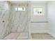 Bathroom showcasing elegant marble tiles, fixtures and a window for ample natural light at 508 Northwood Dr, Raleigh, NC 27609