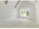 Bedroom showcasing vaulted ceilings and large window with natural lighting and outdoor view at 508 Northwood Dr, Raleigh, NC 27609
