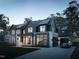 Stunning exterior view of a modern home, complete with a driveway, large windows, and manicured lawn at 508 Northwood Dr, Raleigh, NC 27609