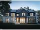 Beautifully landscaped home with modern design featuring large windows and a stone and siding exterior at 508 Northwood Dr, Raleigh, NC 27609