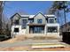 Exterior framing of a modern two-story home, featuring a combination of siding, stone accents, and large windows at 508 Northwood Dr, Raleigh, NC 27609
