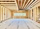 Spacious room showcasing wood framing, exposed ceiling beams, and natural light through large windows at 508 Northwood Dr, Raleigh, NC 27609
