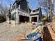 Exterior view of a house under construction, highlighting the two-car garage, siding and open framing at 508 Northwood Dr, Raleigh, NC 27609