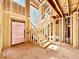 Interior of a home under construction, featuring staircase, exposed wood framing, and large windows at 508 Northwood Dr, Raleigh, NC 27609