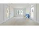 Bright living room featuring natural light from a large window and two entry doors at 508 Northwood Dr, Raleigh, NC 27609