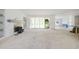 Bright living room with a fireplace, built-in shelves, and access to an outdoor area at 508 Northwood Dr, Raleigh, NC 27609