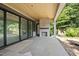 Covered outdoor patio featuring stone fireplace and sliding glass doors at 508 Northwood Dr, Raleigh, NC 27609