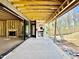 Covered patio with fireplace offering indoor-outdoor living with yard view and access to more under-construction rooms at 508 Northwood Dr, Raleigh, NC 27609