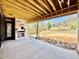 Under-construction covered patio with a fireplace offers a view of the backyard and potential for outdoor living at 508 Northwood Dr, Raleigh, NC 27609