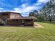 Charming exterior view of a brick apartment building with a green lawn and mature trees under a blue sky at 130 S Estes Dr # B7, Chapel Hill, NC 27514