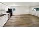 Bright kitchen featuring stainless steel appliances, hardwood floors, white cabinets, and a bright window at 130 S Estes Dr # B7, Chapel Hill, NC 27514