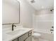 Modern bathroom featuring a sleek vanity, stylish mirror, and tub with shower at 7327 Shawan Rd, Wendell, NC 27591