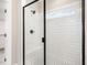 Modern bathroom features a black framed glass shower with tile walls and black and white tile floor at 7327 Shawan Rd, Wendell, NC 27591