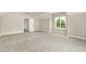 Bright bedroom with neutral carpet, a window, and an open doorway at 7327 Shawan Rd, Wendell, NC 27591