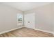 A spacious bedroom features a window and closet with double doors and wood-look flooring at 7327 Shawan Rd, Wendell, NC 27591