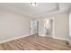 A large bedroom boasts an open doorway and two large windows, showcasing wood-look flooring at 7327 Shawan Rd, Wendell, NC 27591