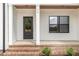 Inviting front porch with brick steps, decorative columns, and a stylish front door for a warm welcome at 7327 Shawan Rd, Wendell, NC 27591