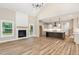 Inviting living space featuring a fireplace, modern lighting, and seamless flow to the kitchen for entertaining at 7327 Shawan Rd, Wendell, NC 27591