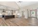 Spacious living area with wood floors, open to the kitchen, creating a seamless and connected living experience at 7327 Shawan Rd, Wendell, NC 27591