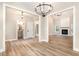Open-concept living space with wood floors, a fireplace, and ample natural light, perfect for gatherings at 7327 Shawan Rd, Wendell, NC 27591