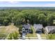 Aerial view of two newly constructed modern homes surrounded by lush greenery at 5305 Dixon Dr, Raleigh, NC 27609