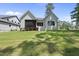 Spacious backyard with a screened-in patio, well-manicured lawn, and mature trees at 5305 Dixon Dr, Raleigh, NC 27609