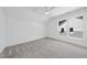 Neutral bedroom offers soft carpeting, a ceiling fan, and a large bright window at 5305 Dixon Dr, Raleigh, NC 27609