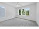 Airy bedroom featuring plush carpet and a bright window with a tranquil outdoor view at 5305 Dixon Dr, Raleigh, NC 27609