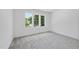 Spacious bedroom featuring soft carpeting and a large window providing natural light at 5305 Dixon Dr, Raleigh, NC 27609