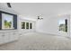 Expansive bonus room featuring a sleek wet bar, plush carpeting and multiple windows at 5305 Dixon Dr, Raleigh, NC 27609