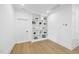 Clean bonus room featuring custom built-in shelving and light wood flooring at 5305 Dixon Dr, Raleigh, NC 27609