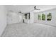 Large bonus room with a wet bar, wine fridge, blue backsplash, plush carpeting and multiple windows at 5305 Dixon Dr, Raleigh, NC 27609
