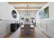 Formal dining room with modern chandelier, wood-beam ceiling and accent wainscoting at 5305 Dixon Dr, Raleigh, NC 27609