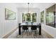 Elegant dining room with lots of natural light and views of the greenery from large windows at 5305 Dixon Dr, Raleigh, NC 27609